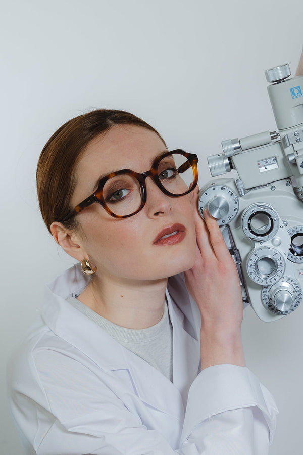 Flora Ecaille eyeglasses — round frame, worn by a woman