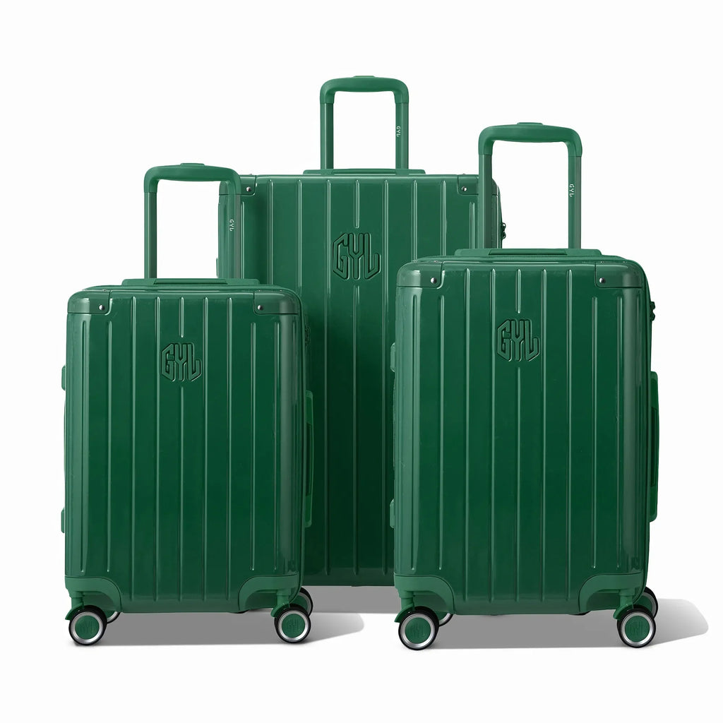 Tres maletas rígidas GYL Intemporelle verde abeto, formato cabina y bodega, con asa trolley desplegada.  #couleur_sapin