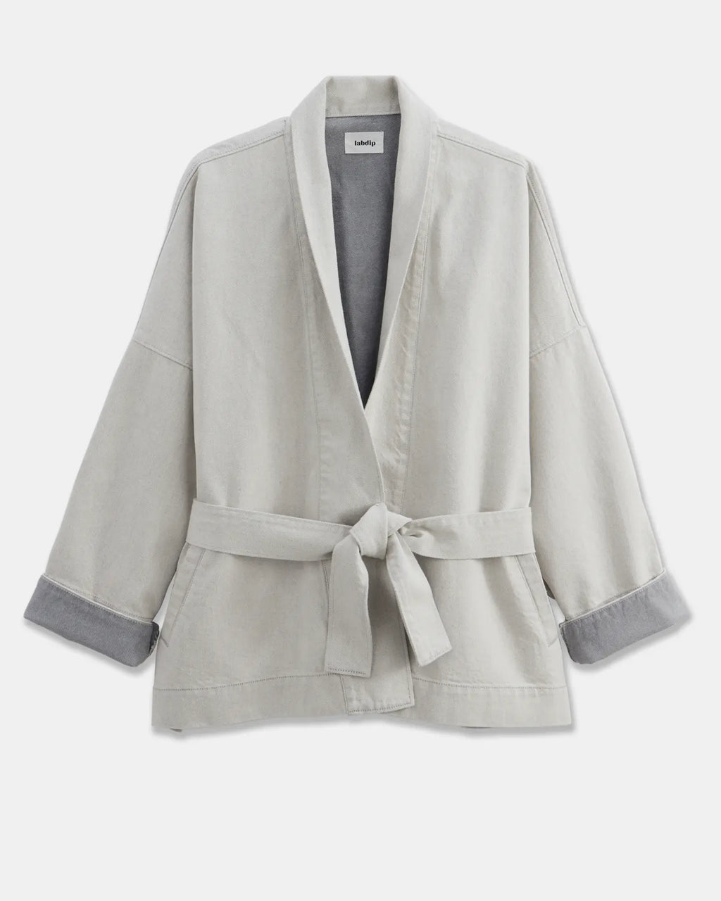 Light jacket in undyed granite gray denim, loose fit with wide sleeves and tie belt, ideal for a casual and feminine style.