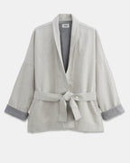 Light jacket in undyed granite gray denim, loose fit with wide sleeves and tie belt, ideal for a casual and feminine style.