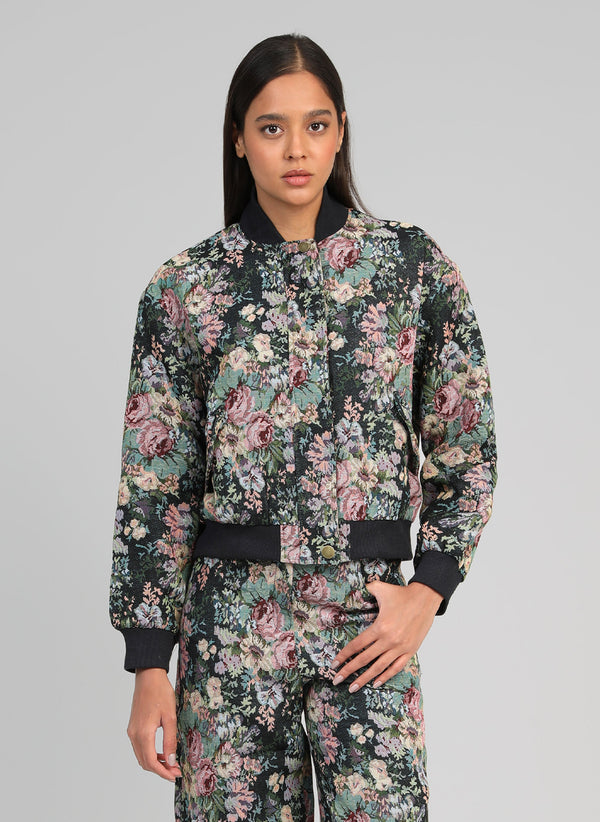 An'ge – Cassyana Black Jacket, model wearing a black, pink and green floral bomber jacket
