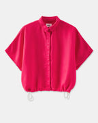 women's flowing shirt in light fuchsia fabric with classic collar and wide short sleeves, loose fit adjustable with drawstrings at the hem