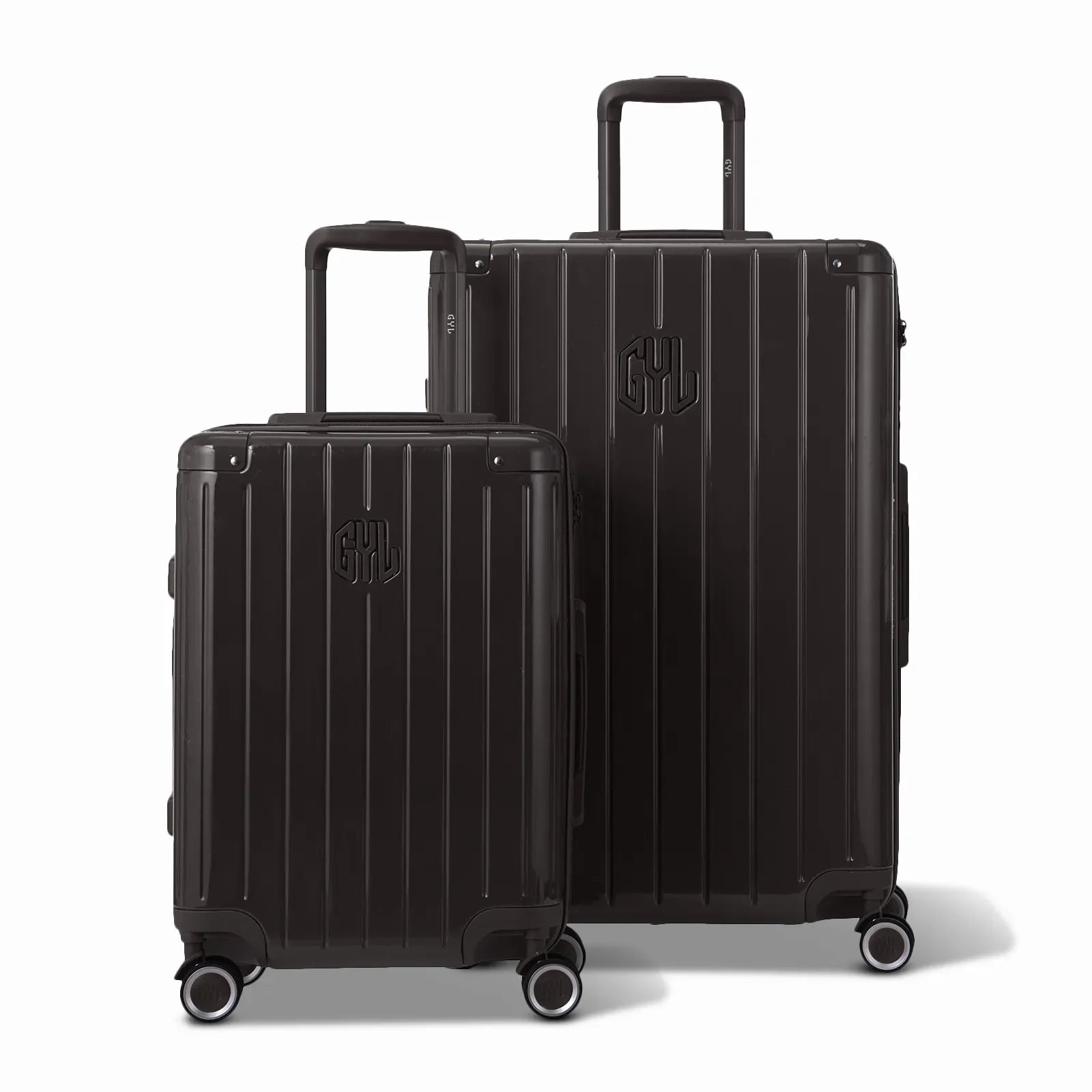 Two GYL Intemporelle rigid suitcases in black, 2 sizes, with extended trolley handle. #couleur_noir