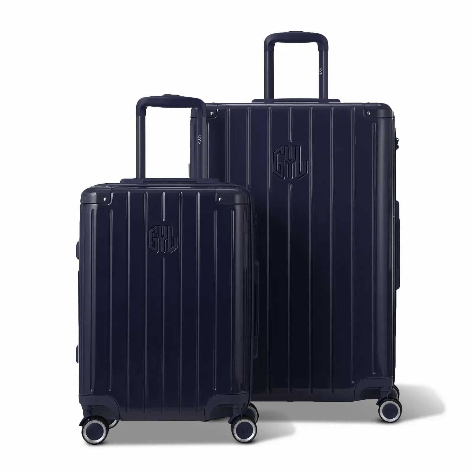 Two GYL Intemporelle navy hard-shell suitcases, cabin and hold sizes, with extended trolley handle. #couleur_marine