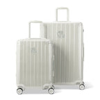 Two GYL Intemporelle sand hard-shell suitcases, cabin and hold sizes, with trolley handle extended. #couleur_sable