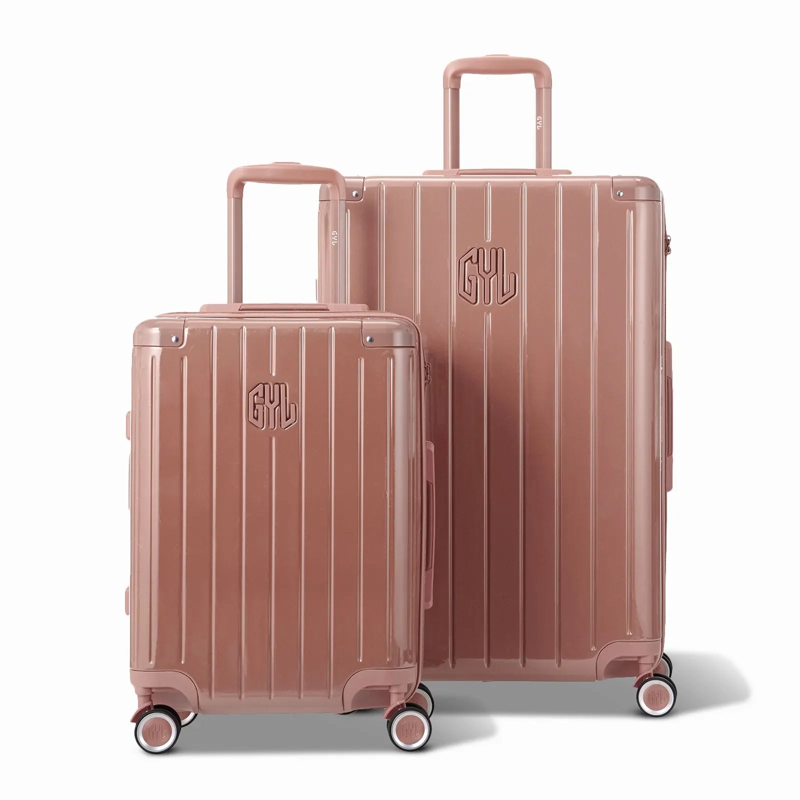 Two GYL Intemporelle rose gold hard-shell suitcases, cabin and hold sizes, with extended trolley handle. #couleur_rose gold