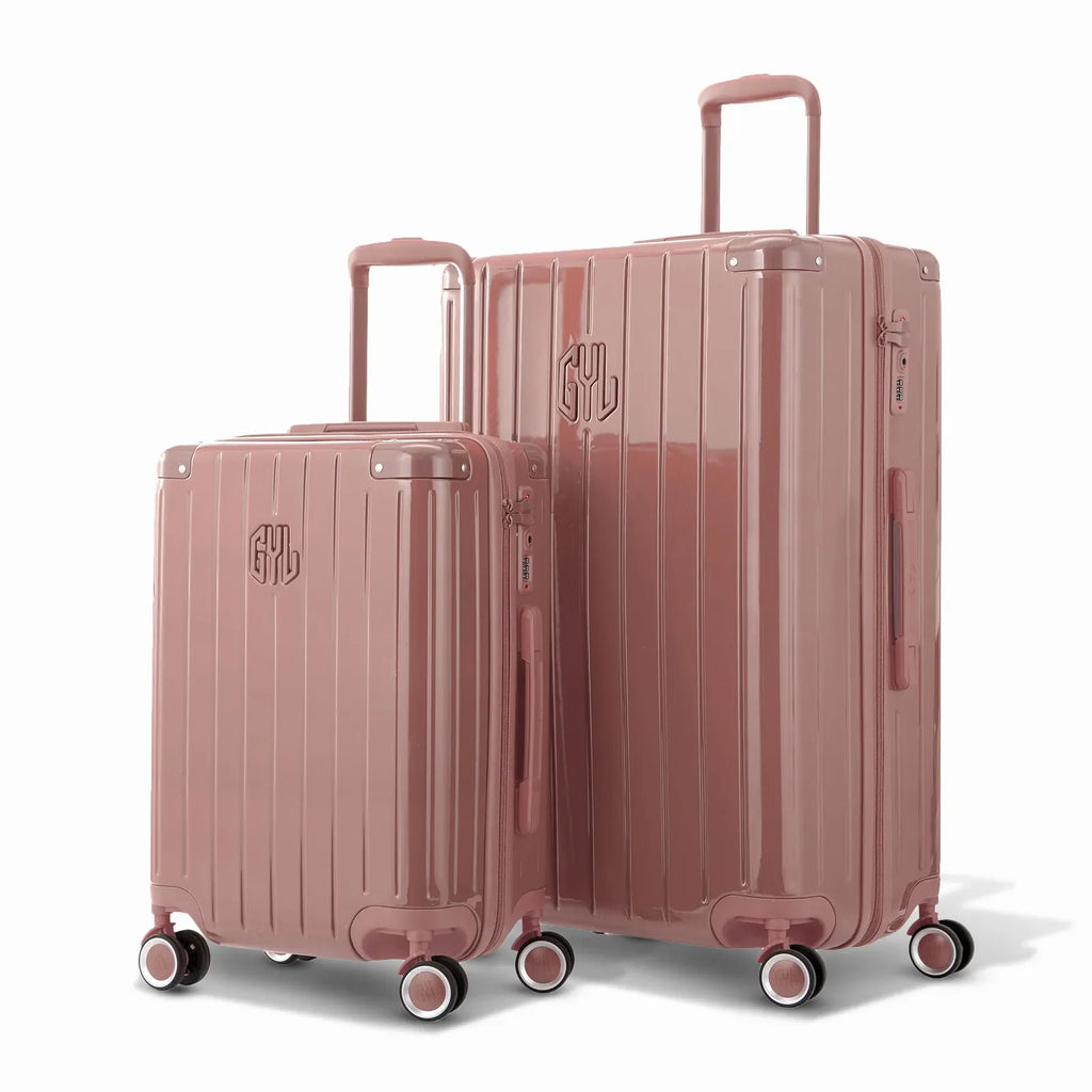Duo of GYL Intemporelle rose gold hard-shell suitcases with ribbed shells and telescopic handles. #couleur_rose gold