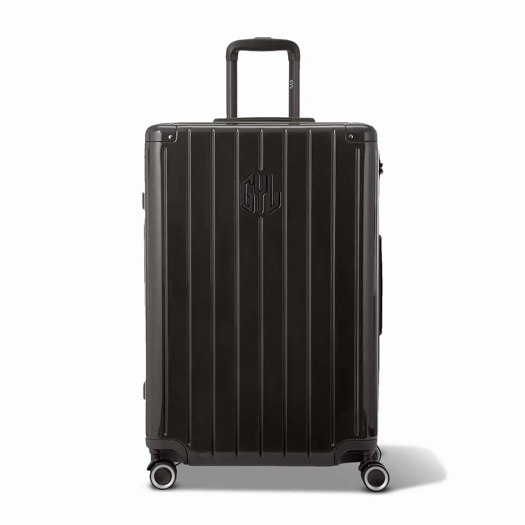 Front view of the GYL Intemporelle black hard-shell suitcase, embossed logo and 360-degree wheels. #couleur_noir