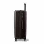 Side view of the GYL Intemporelle black hard-shell suitcase with telescopic handle and TSA lock. #couleur_noir