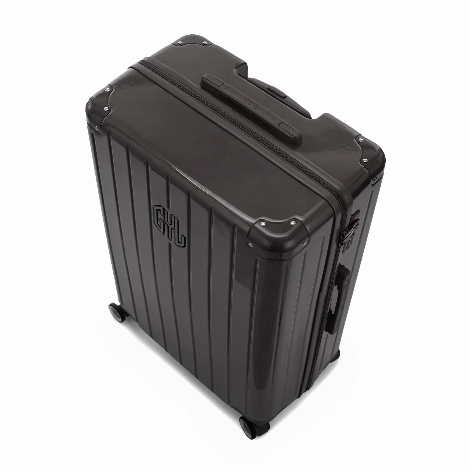 Angled view of the GYL Intemporelle black hard-shell suitcase with reinforced corners and glossy ribbed shell. #couleur_noir