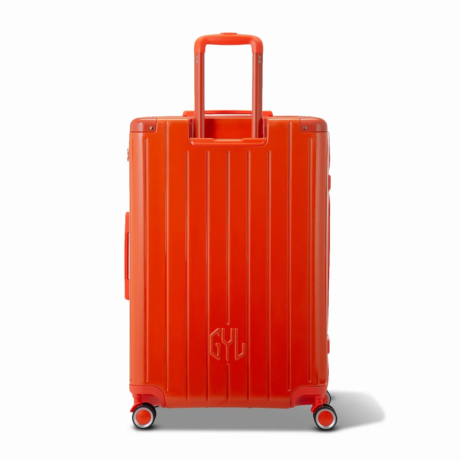 Rear view of the GYL Intemporelle orange hard-shell suitcase with integrated handles and swivel wheels. #couleur_orange foncé