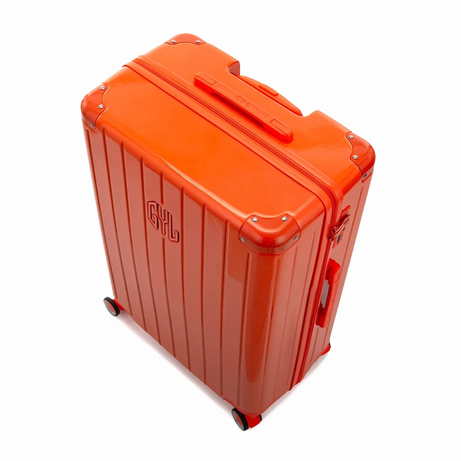 Angled view of the GYL Intemporelle orange hard-shell suitcase with reinforced corners and glossy ribbed shell. #couleur_orange foncé