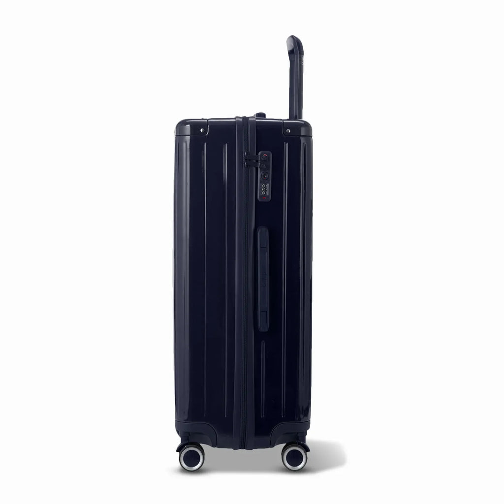 Side view of the GYL Intemporelle navy hard-shell suitcase with telescopic handle and TSA lock. #couleur_marine