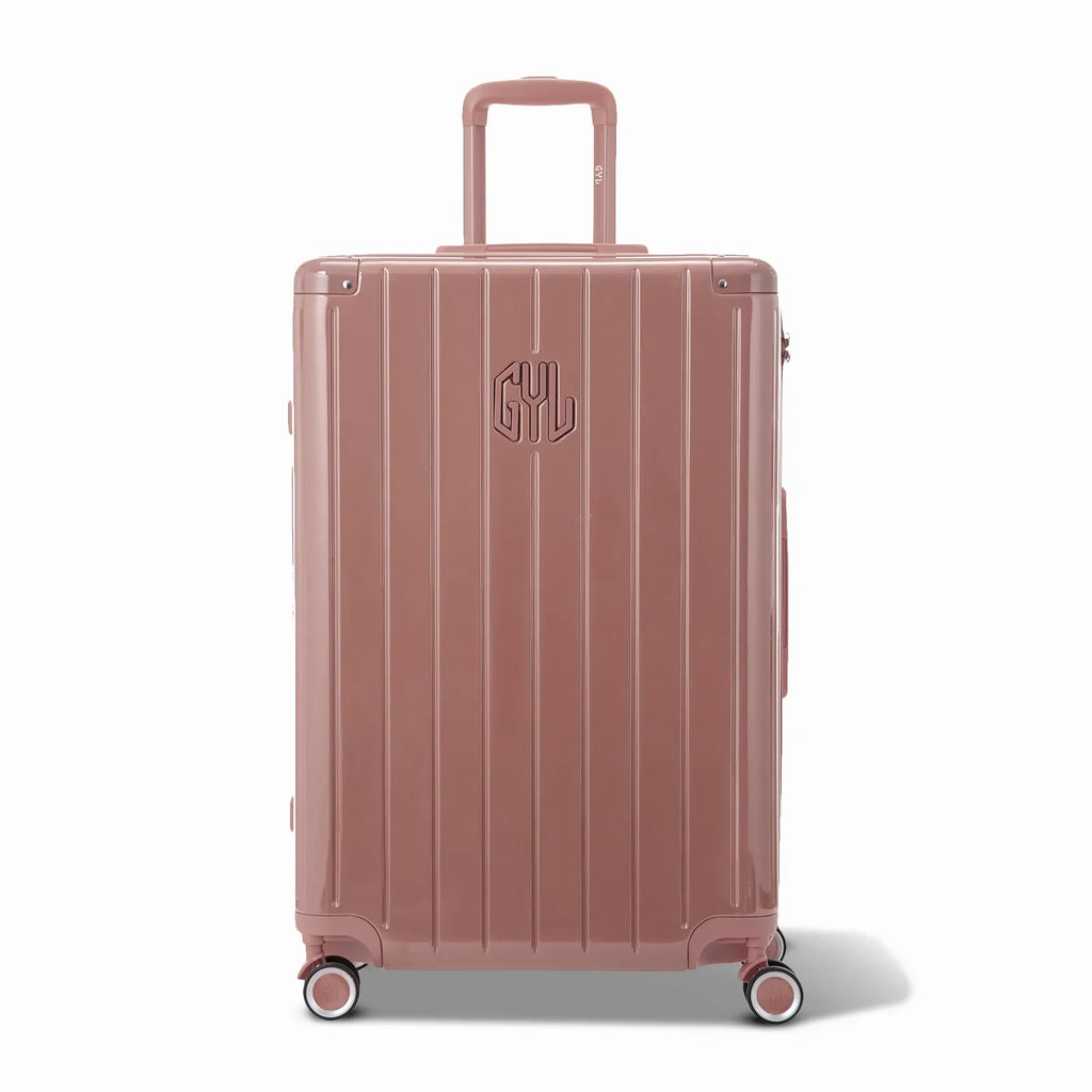 Front view of the GYL Intemporelle rose gold hard-shell suitcase, embossed logo and 360-degree wheels. #couleur_rose gold