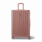 Front view of the GYL Intemporelle rose gold hard-shell suitcase, embossed logo and 360-degree wheels. #couleur_rose gold