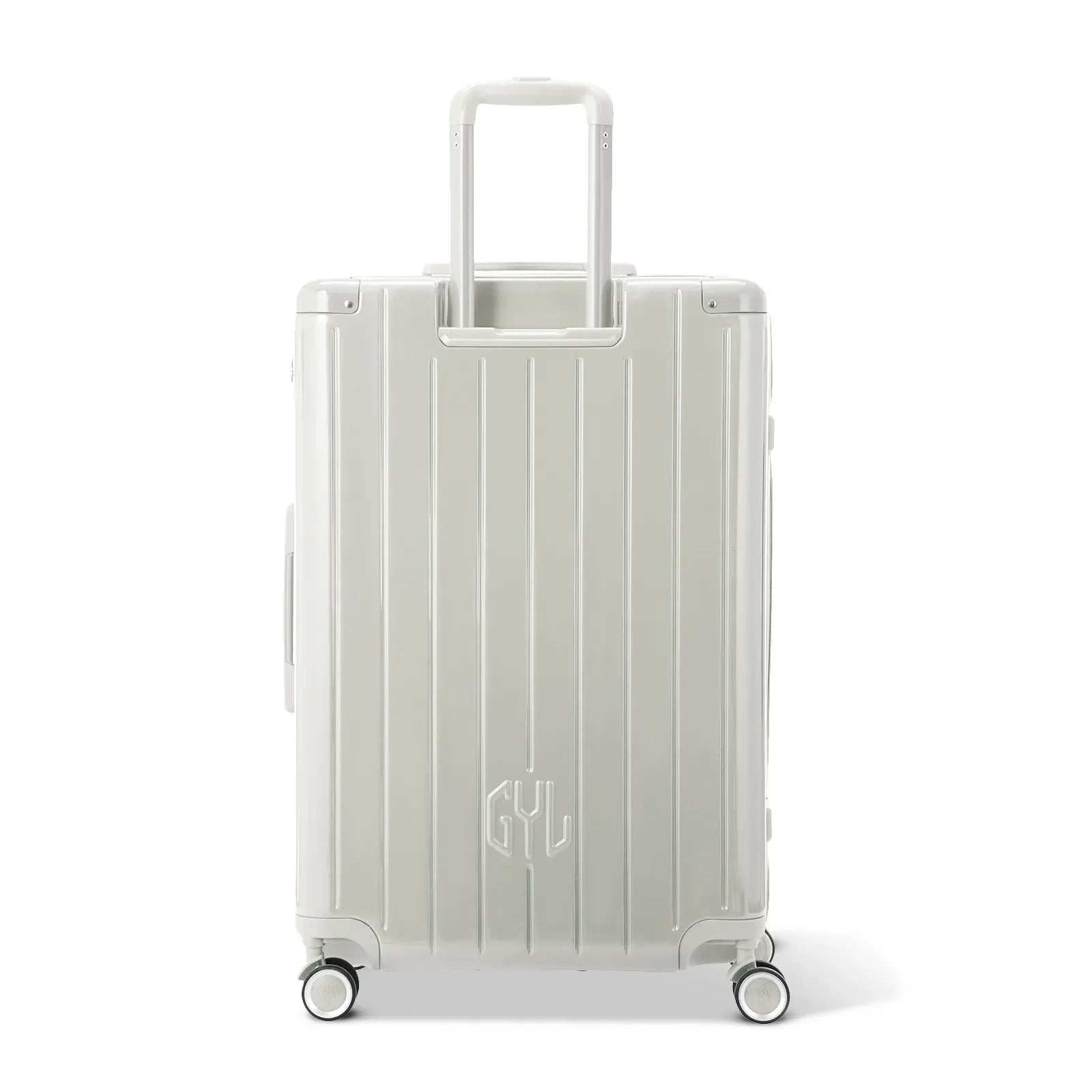 Rear view of the GYL Intemporelle sand hard-shell suitcase with integrated handles and swivel wheels. #couleur_sable
