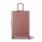 Rear view of the GYL Intemporelle rose gold hard-shell suitcase with integrated handles and swivel wheels. #couleur_rose gold