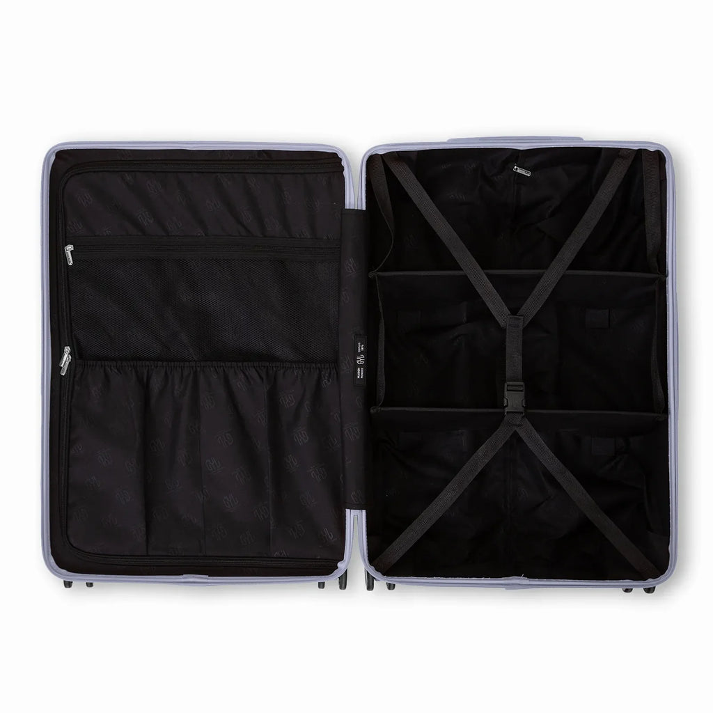 Compartmentalised interior of the GYL Intemporelle silver suitcase with cross straps and mesh pockets. #couleur_argent