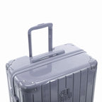 Extended GYL telescopic trolley handle on the Intemporelle silver polycarbonate suitcase. #couleur_argent