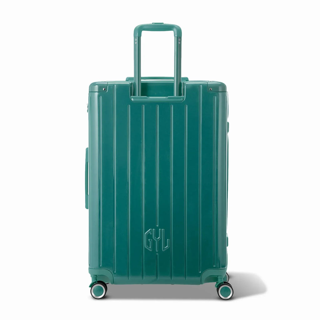 Rear view of the GYL Intemporelle water green hard-shell suitcase with integrated handles and spinner wheels. #couleur_vert