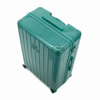 Angled view of the GYL Intemporelle water green hard-shell suitcase with reinforced corners and glossy ribbed shell. #couleur_vert