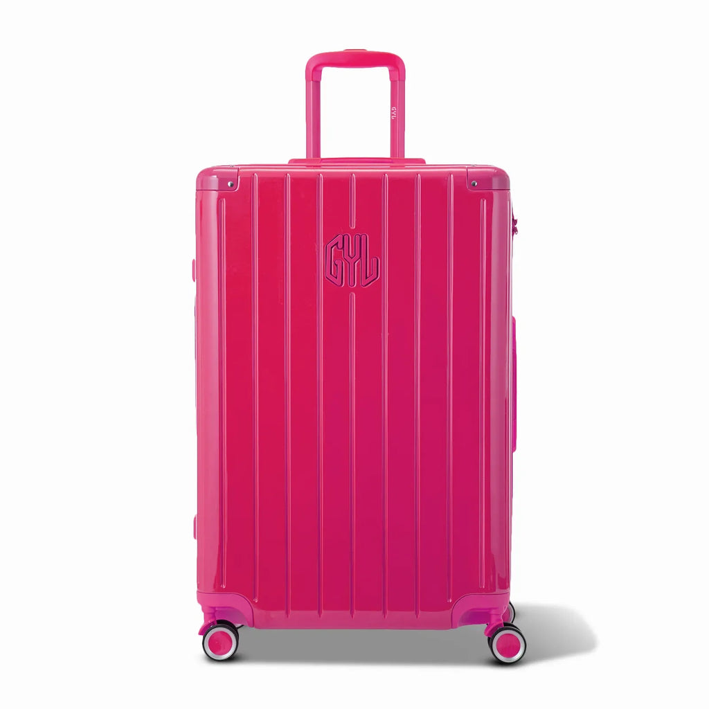 Front view of the GYL Intemporelle fuchsia hard-shell suitcase, embossed logo and 360-degree wheels. #couleur_fuchsia