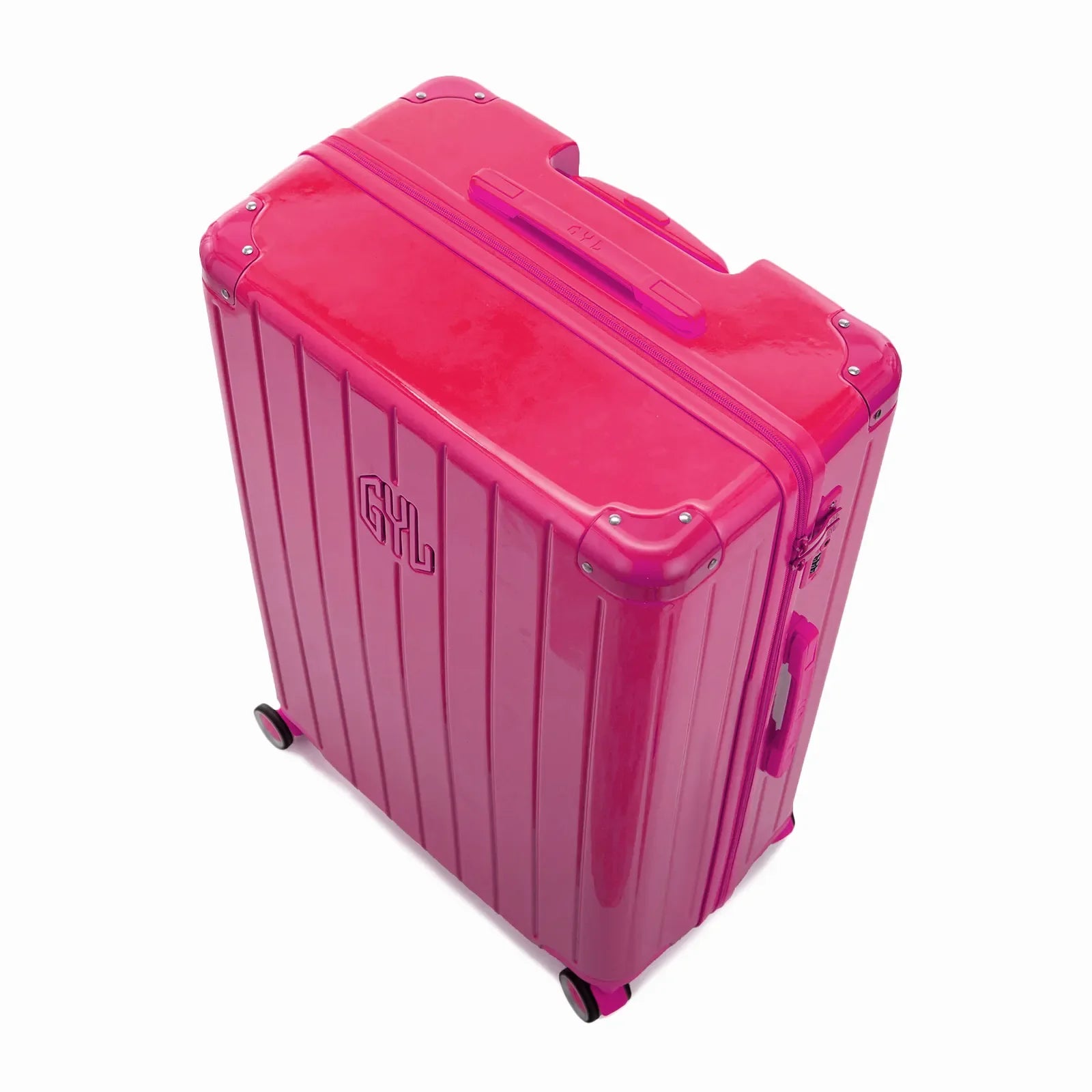Angled view of the GYL Intemporelle fuchsia hard-shell suitcase with reinforced corners and glossy ribbed shell. #couleur_fuchsia