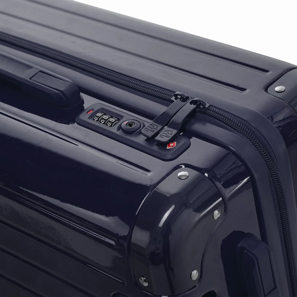 TSA combination lock and double GYL zip slider on the Intemporelle navy hard-shell suitcase. #couleur_marine