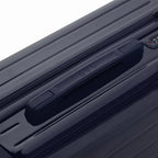 Rigid top handle of the GYL Intemporelle navy suitcase with embossed logo on top. #couleur_marine