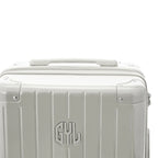 Rigid top handle of the GYL Intemporelle sand suitcase with embossed logo on top. #couleur_sable
