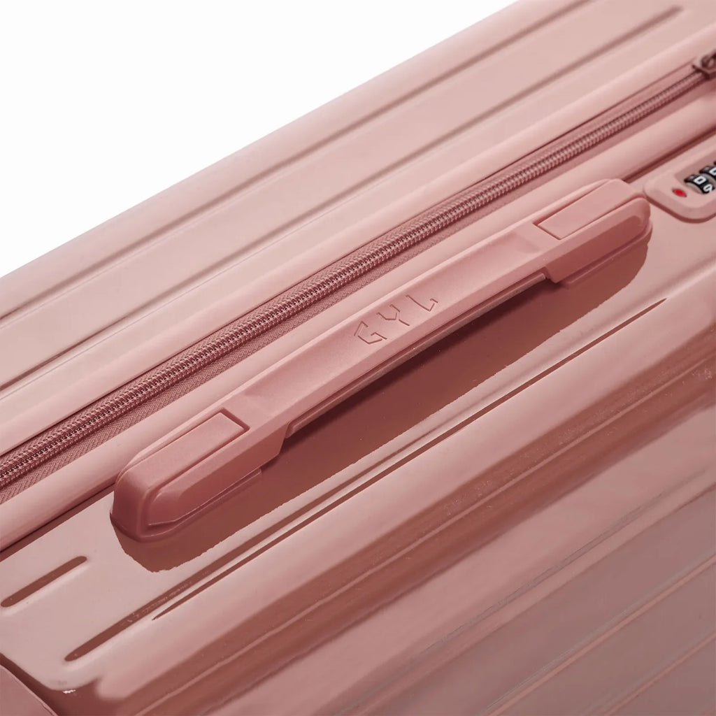 Rigid top handle of the GYL Intemporelle rose gold suitcase with embossed logo on top. #couleur_rose gold