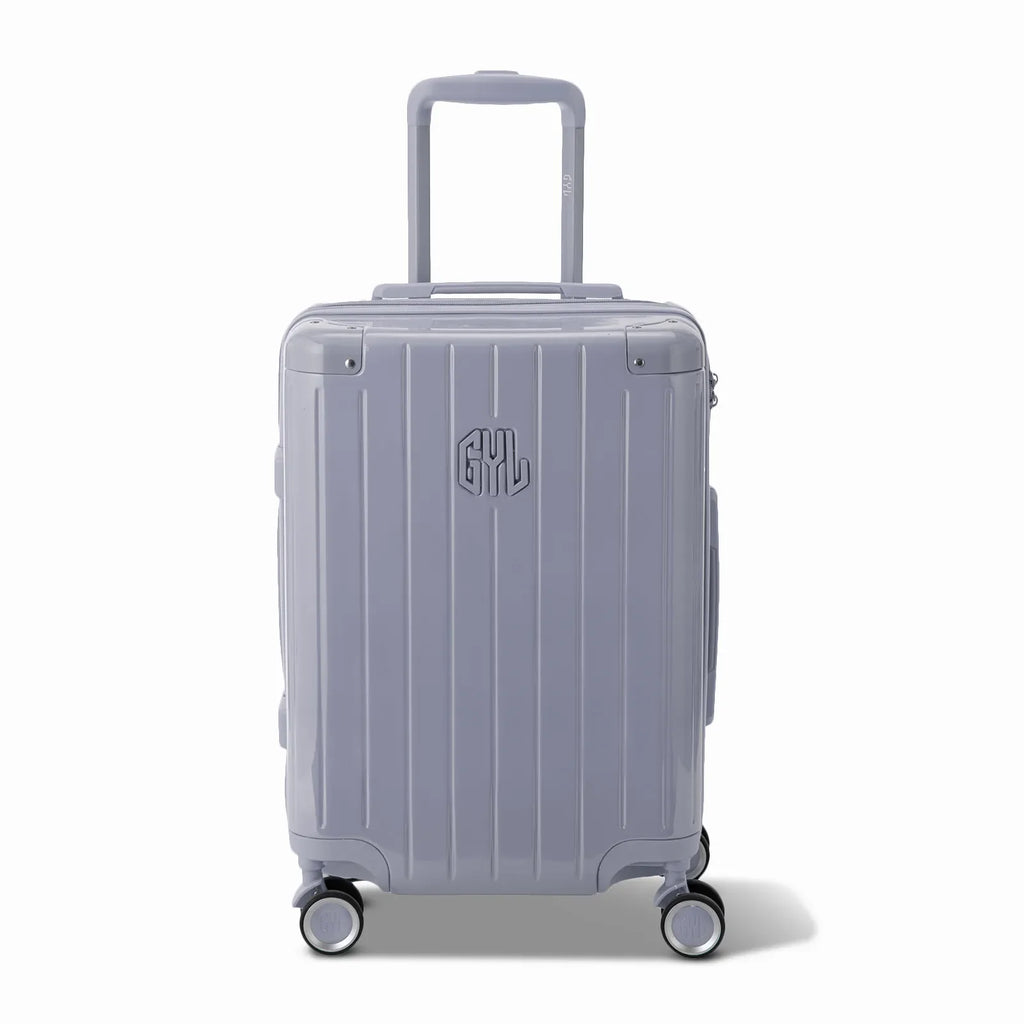 Front view of the GYL Intemporelle silver hard-shell suitcase, embossed logo and 360-degree wheels. #couleur_argent