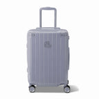 Front view of the GYL Intemporelle silver hard-shell suitcase, embossed logo and 360-degree wheels. #couleur_argent