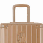 Close-up on the trolley handle and GYL logo of the champagne trunk suitcase. #couleur_champagne