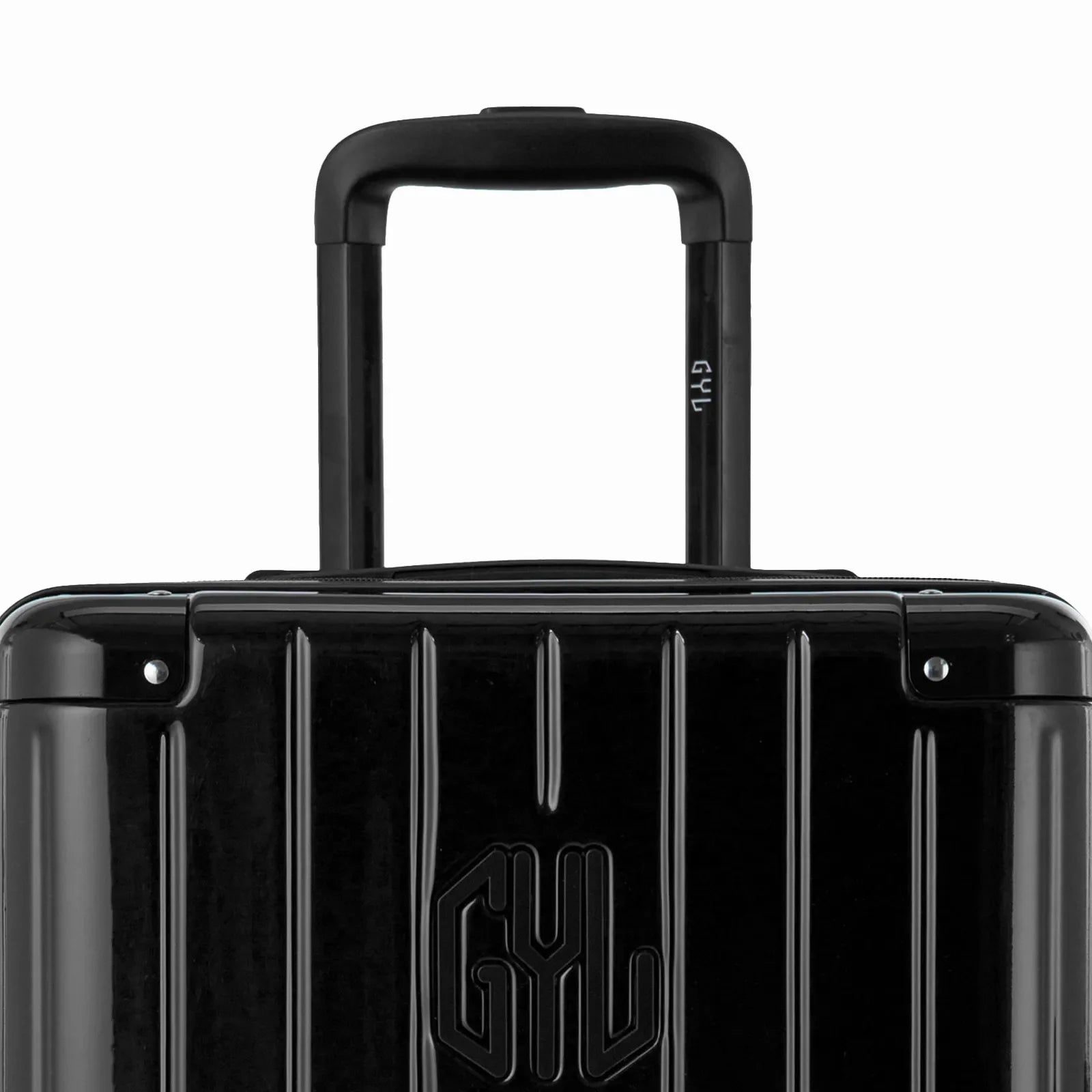 Close-up on the trolley handle and GYL logo of the black trunk suitcase. #couleur_noir