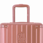 Close-up on the trolley handle and GYL logo of the rose gold trunk suitcase. #couleur_rose gold