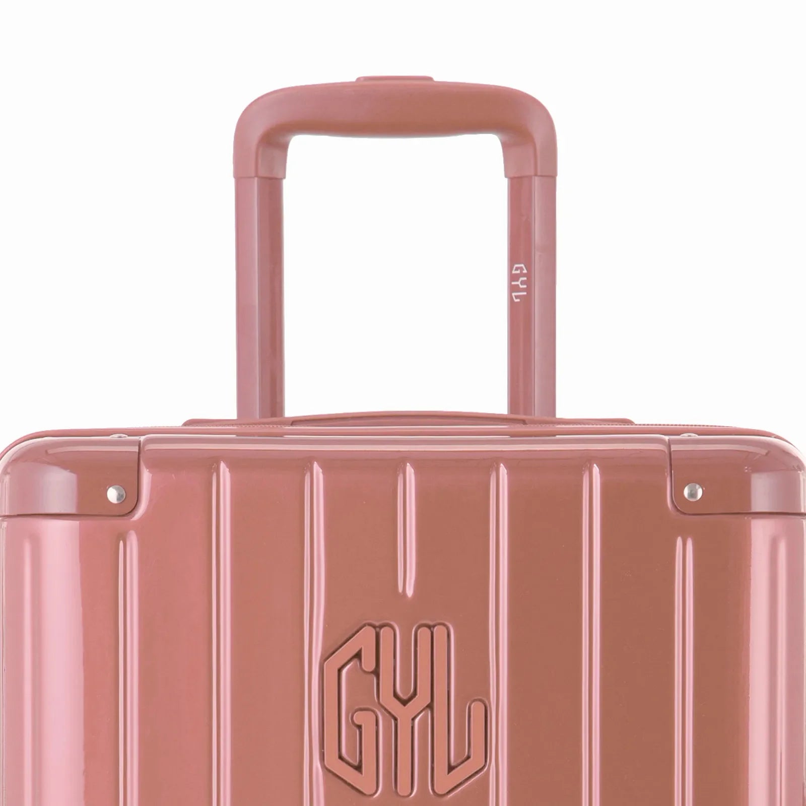 Close-up on the trolley handle and GYL logo of the rose gold trunk suitcase. #couleur_rose gold