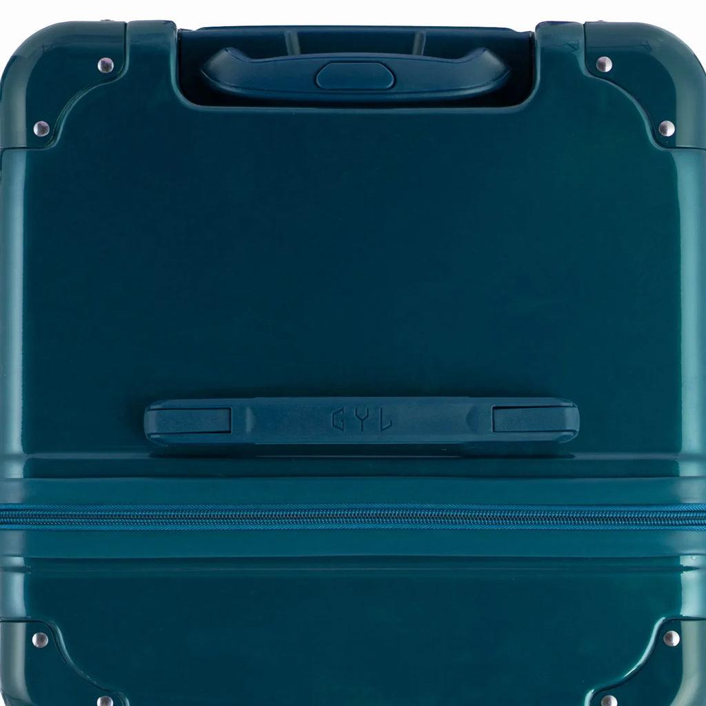 Top view of the GYL trunk suitcase in fir green polycarbonate, with central handle and reinforced corners. #couleur_sapin