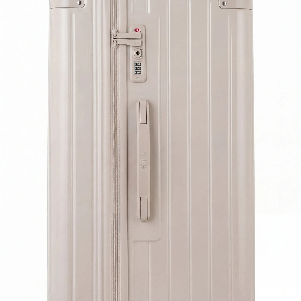 Detail of the TSA lock and side handle on the nude trunk suitcase. #couleur_nude