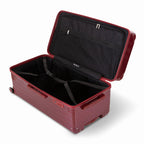 Interior of the open GYL XL dark red trunk suitcase, with cross straps. #couleur_red foncé