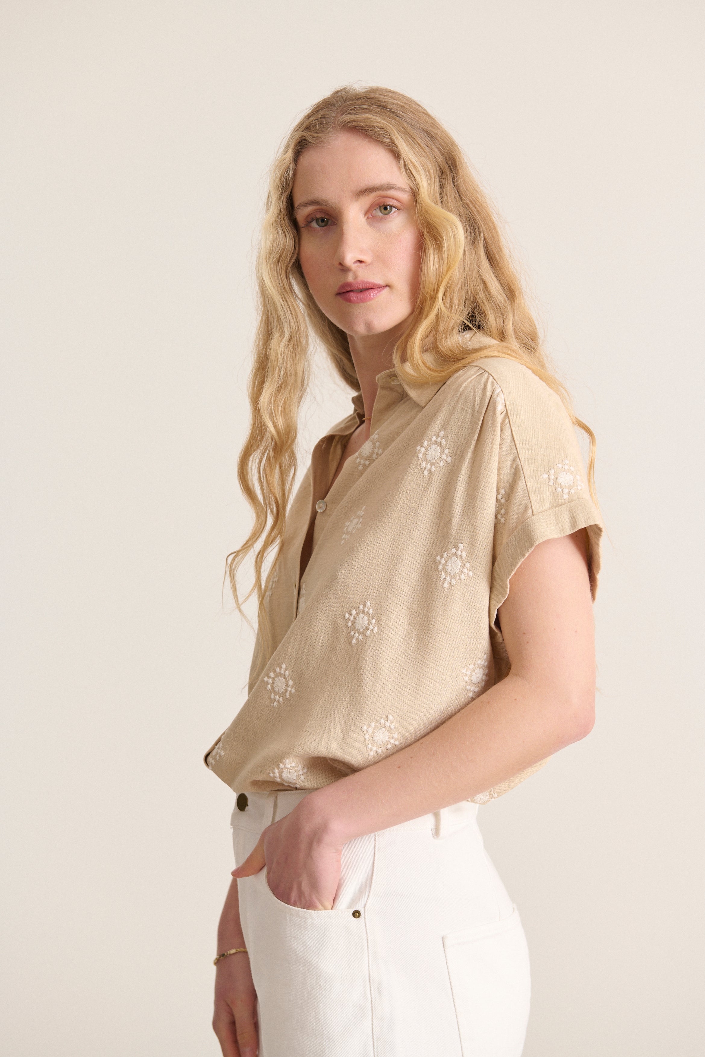 Beige top with beige shirt collar and embroidery with structured cutout and worked details spring summer collection