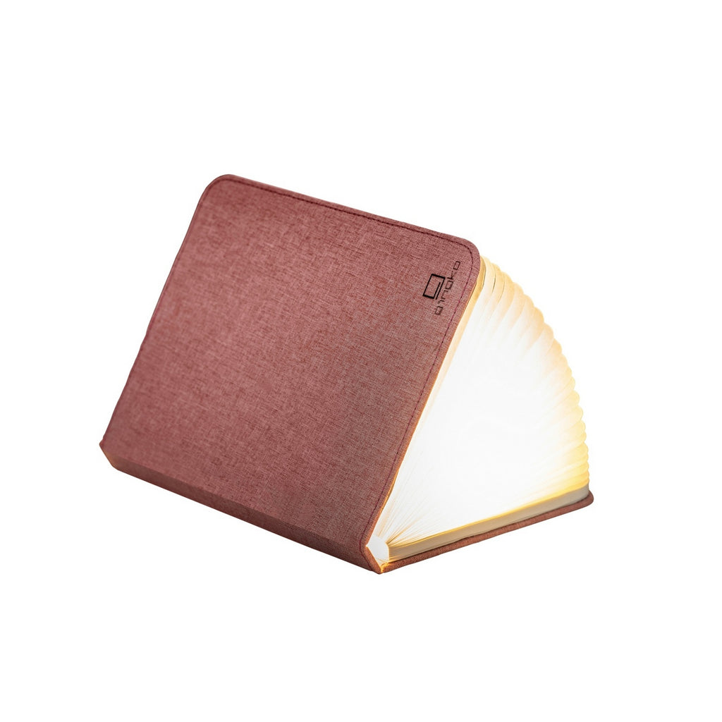 Gingko Design – Lampe Smart Book LED - Lin Rose Poudré - 2 Tailles, livre lumineux ouvert, posé sur une surface blanche, vue de face