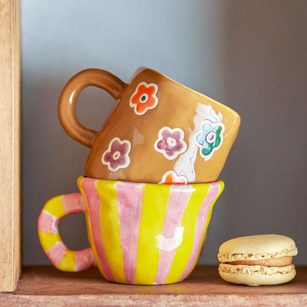Colourful striped mug with flowers inside, decorative 