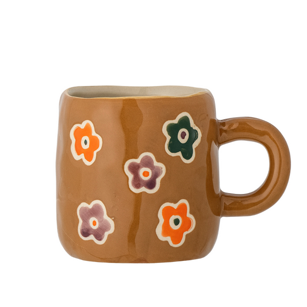 Brown espresso cup with decorative flowers inside 