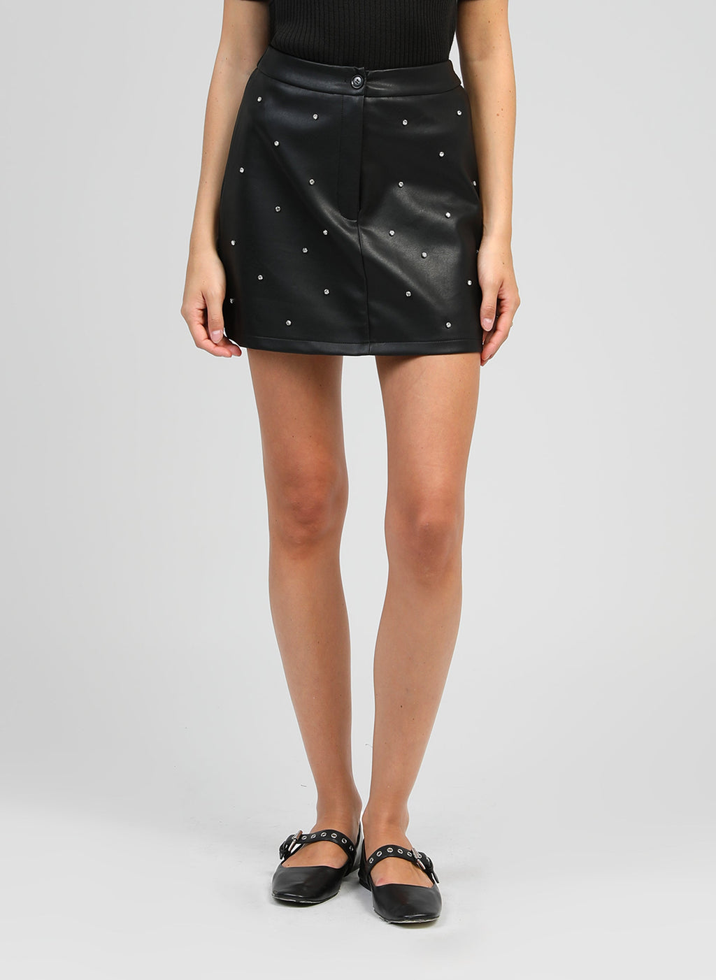 An'ge – Black Jutinia Short Skirt, black studded faux-leather short skirt worn by a model