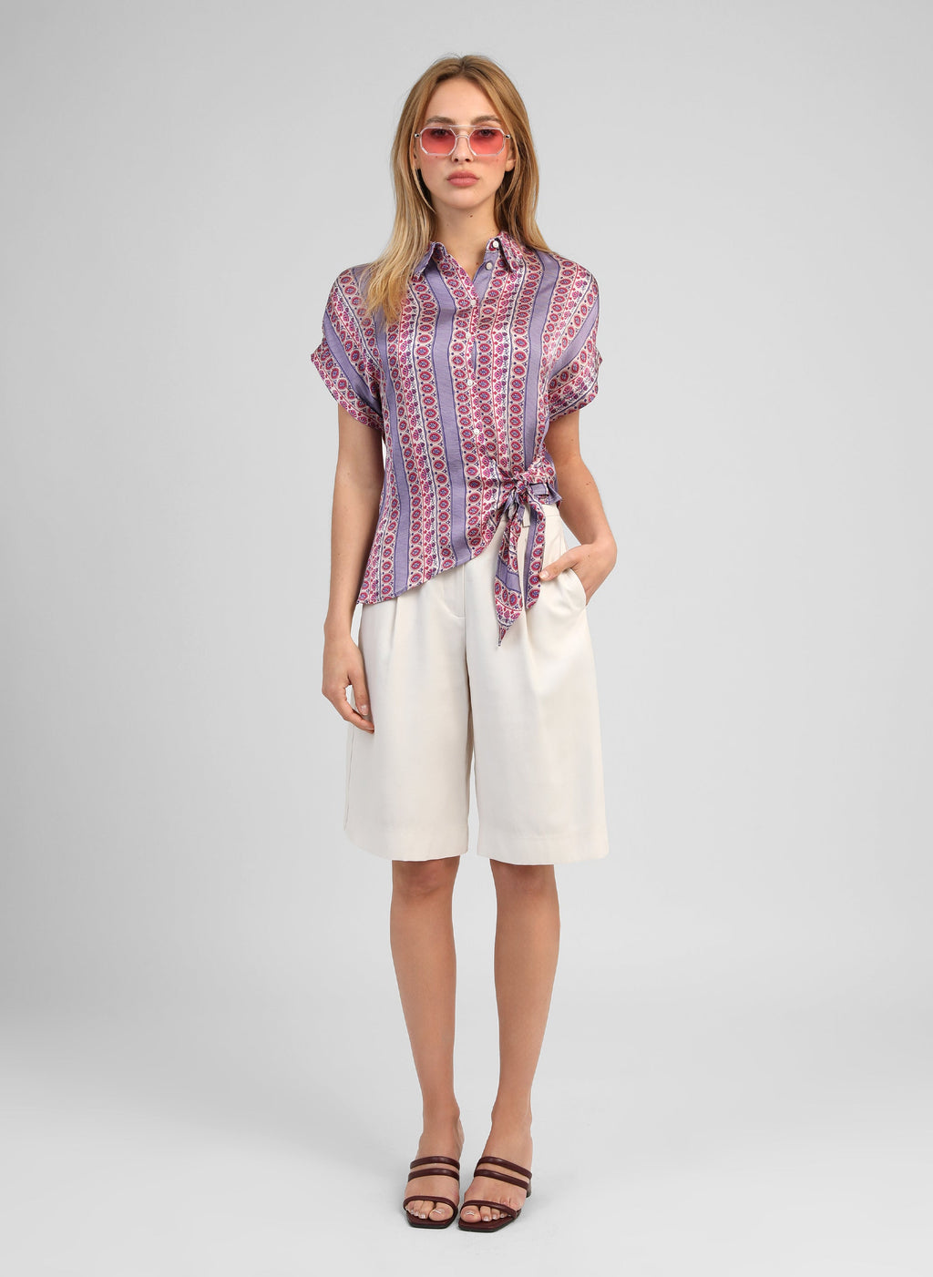 An'ge – Kaviny Diagola Ink Shirt, front view of model wearing a patterned shirt and white shorts