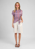 An'ge – Kaviny Diagola Ink Shirt, front view of model wearing a patterned shirt and white shorts