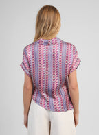 An'ge – Kaviny Diagola Ink Shirt, back view of blonde woman wearing a colourful patterned blouse