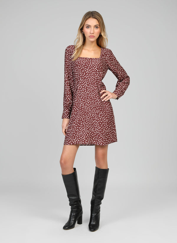 An'ge – Mawill Jakaranda Choco Short Dress, model wearing a brown polka dot dress and black boots