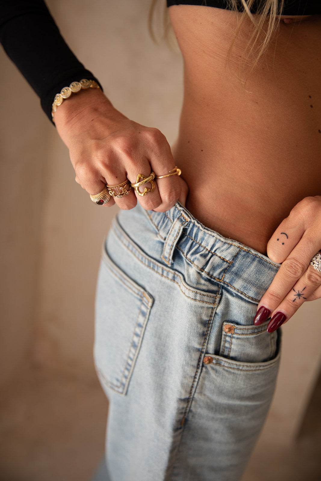 Detail of the side elastics of raw maternity jeans without headband
